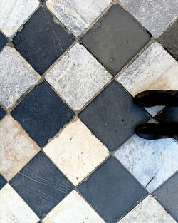 Low section of person on tiled floor