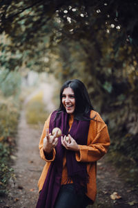 Young woman smiling while standing on land