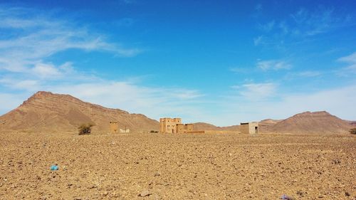 Scenic view of desert against blue sky