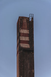 Low angle view of old building against clear blue sky