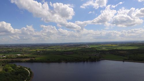 Scenic view of agricultural landscape against sky