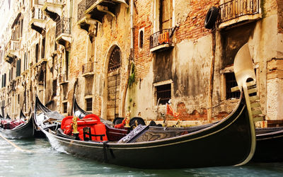 Boats in canal along buildings