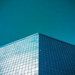 Low angle view of modern building against clear blue sky