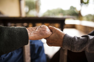 Elderly couple shaking hands