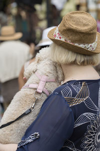 A woman is holding a dog