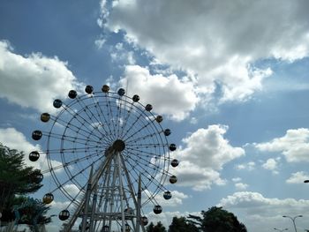 Low angle view of ferris wheel against sky