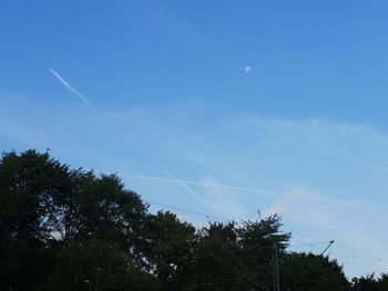 Low angle view of vapor trail against blue sky