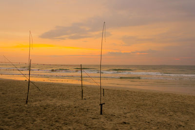 Scenic view of beach against sky during sunset