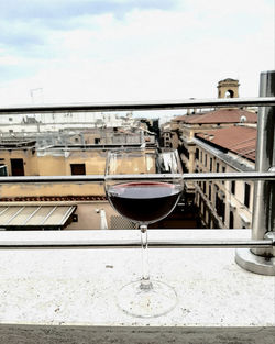 Wine glass on table against sky