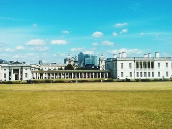 Buildings in city against blue sky