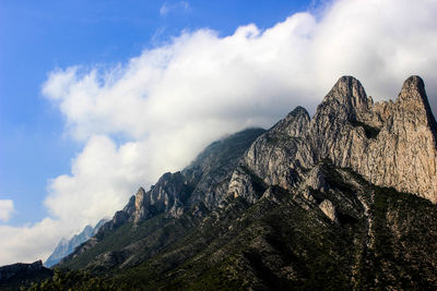 Low angle view of rocky mountains against sky