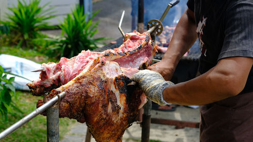 Midsection of man preparing food