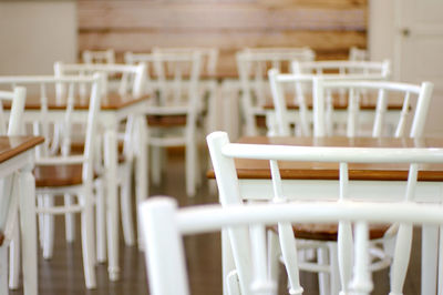 Empty chairs in cafe coffee shop wood and white 