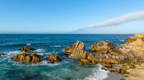 Panoramic view of rocks in sea against sky