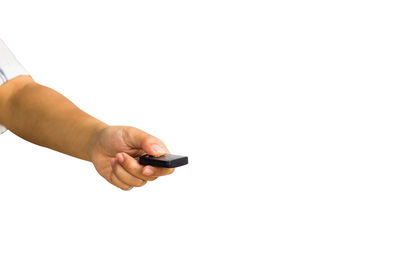 Close-up of hand holding camera against white background