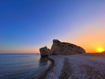 Scenic view of sea against clear sky during sunset