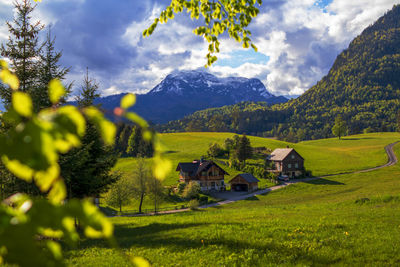 Scenic view of field and mountains against sky