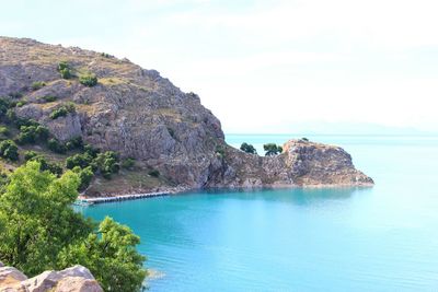 Scenic view of sea and rock formation against sky