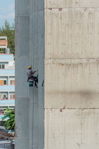 Man working at construction site against building