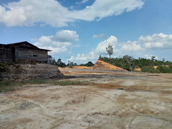 Houses on field against sky