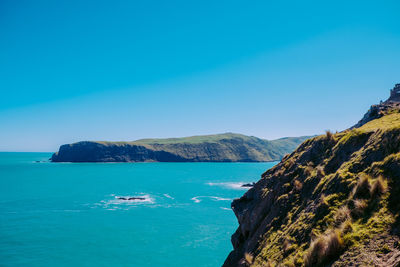 Scenic view of sea against clear blue sky