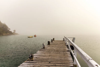 Pier over sea against clear sky