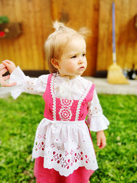 Portrait of cute girl standing on field