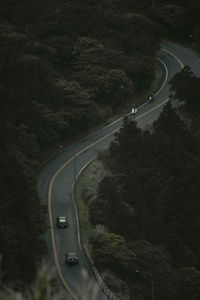 High angle view of vehicles on road amidst trees