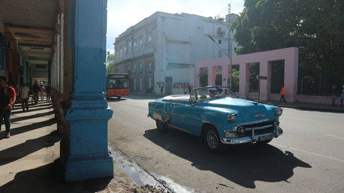 Cars on street by buildings in city