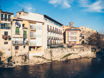 Buildings by sea against sky in city