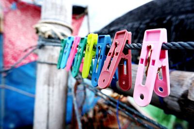 Close-up of clothespins hanging on clothesline