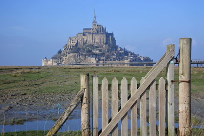 View of old building against clear blue sky  m'ont saint michel normandy