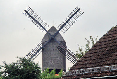 Low angle view of traditional windmill against clear sky