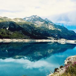 Scenic view of lake and mountains against sky