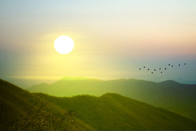 Scenic view of mountains against sky during sunset