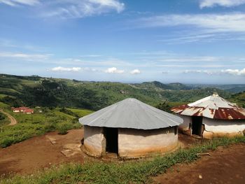 Built structure on field against sky