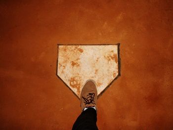 Low section of person standing on tiled floor