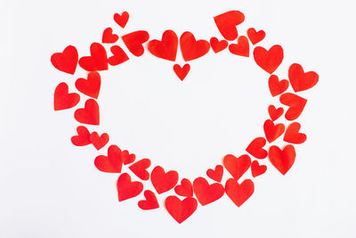 Close-up of red heart shape against white background