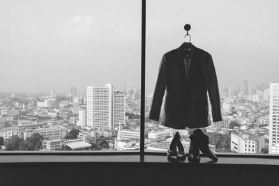 Man and woman standing by cityscape against sky