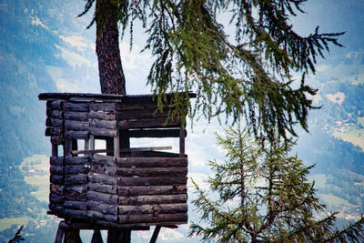 Bench in park against sky