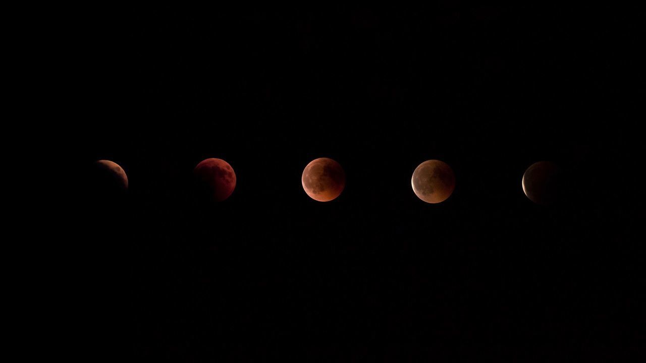 LOW ANGLE VIEW OF MOON IN BLACK BACKGROUND