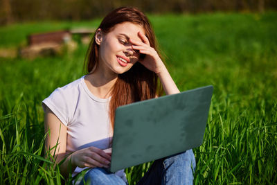 Portrait of young woman using digital tablet