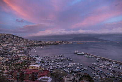 High angle view of townscape by sea against sky