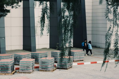 People walking by building in city