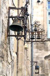 Low angle view of street light against wall