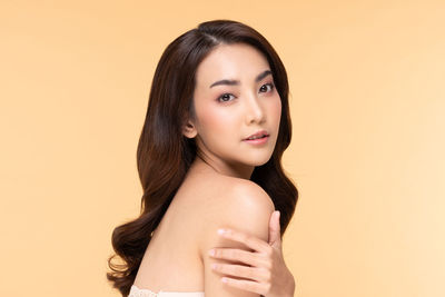 Portrait of a beautiful young woman over white background