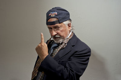 Portrait of man standing against wall