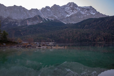 Scenic view of lake and mountains against sky