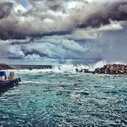 Scenic view of sea against cloudy sky