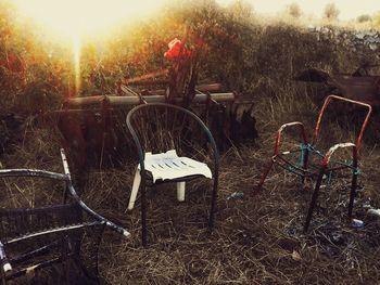 Chairs on field against sky